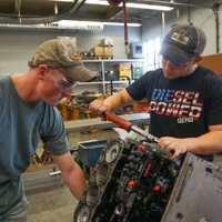 students working in the power machinery shop